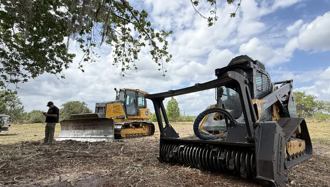 Forestry mulcher attachment shredding overgrown brush for site preparation